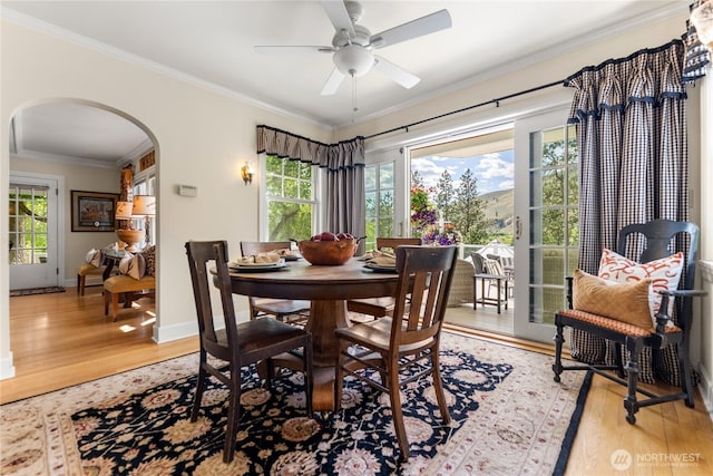 3A Ross Rd, Twisp, WA 98856 - dining room featuring arched walkways, light wood-type flooring, ornamental molding, and a ceiling fan