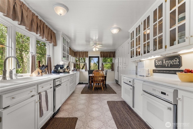 3A Ross Rd, Twisp, WA 98856 - kitchen featuring white oven, light countertops, glass insert cabinets, and white cabinetry