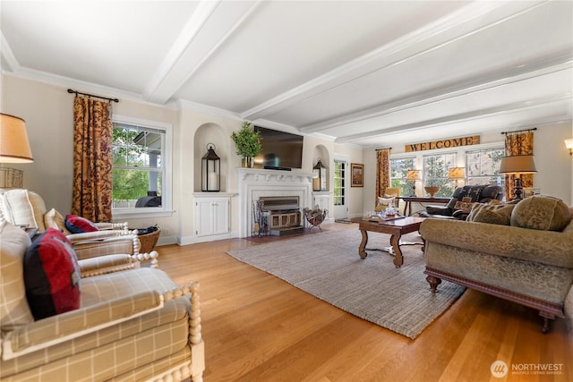 3A Ross Rd, Twisp, WA 98856 - living room featuring plenty of natural light, beamed ceiling, light wood finished floors, and a fireplace with flush hearth