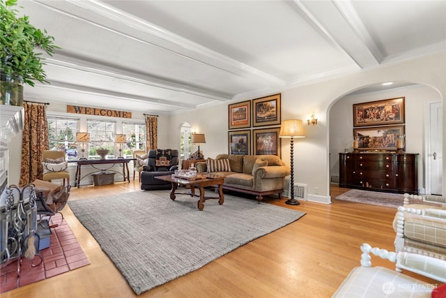 3A Ross Rd, Twisp, WA 98856 - living area featuring arched walkways, beamed ceiling, wood finished floors, and a fireplace