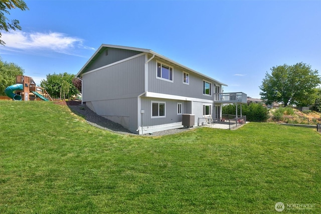 716 Cascadia Park Dr, Yakima, WA 98901 - rear view of property featuring a lawn, a playground, a patio area, and a balcony