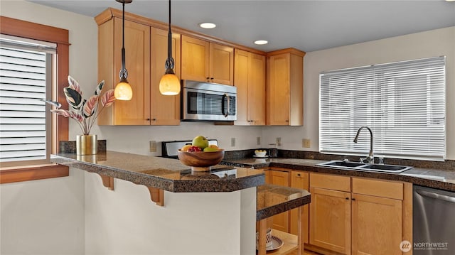 743 94th St N Unit B, Seattle, WA 98103 - kitchen featuring appliances with stainless steel finishes, tile counters, a kitchen bar, a peninsula, and recessed lighting