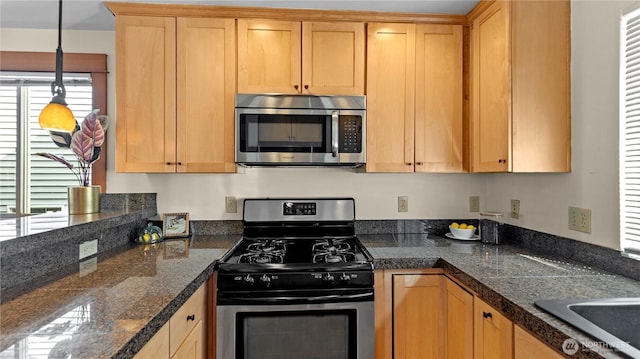 743 94th St N Unit B, Seattle, WA 98103 - kitchen featuring appliances with stainless steel finishes, tile counters, and hanging light fixtures