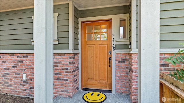 743 94th St N Unit B, Seattle, WA 98103 - view of exterior entry featuring brick siding and covered porch
