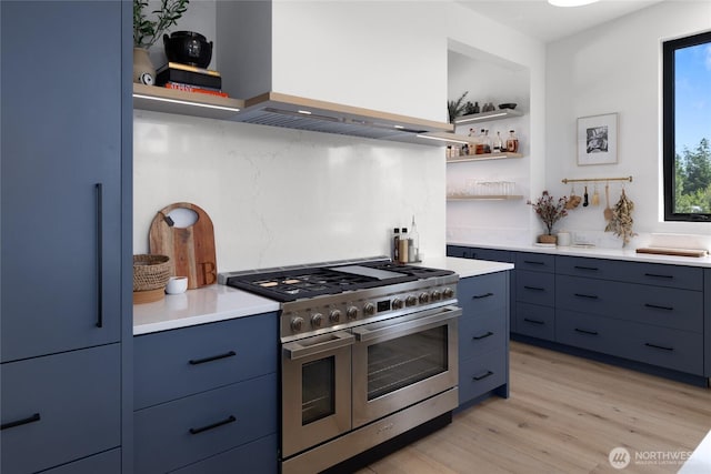 3847 Swiftwater Dr, Cle Elum, WA 98922 - kitchen with range with two ovens, open shelves, refrigerator, and blue cabinetry