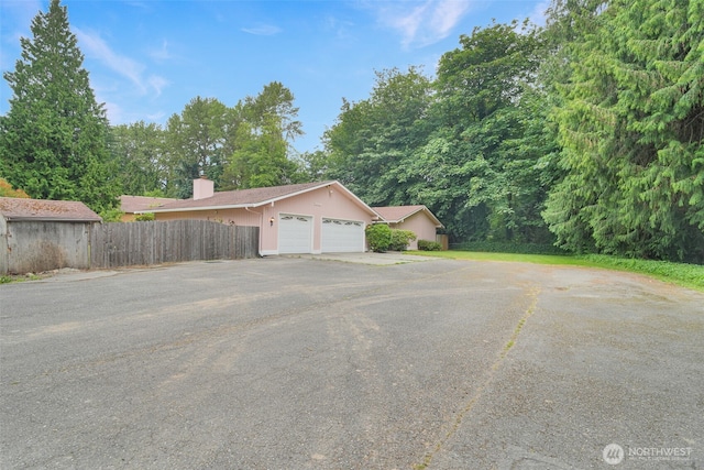 2004 SW 306th Pl, Federal Way, WA 98023 - view of side of property with a garage and a chimney
