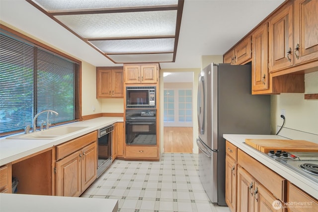 2004 SW 306th Pl, Federal Way, WA 98023 - kitchen with black appliances, light flooring, and light countertops