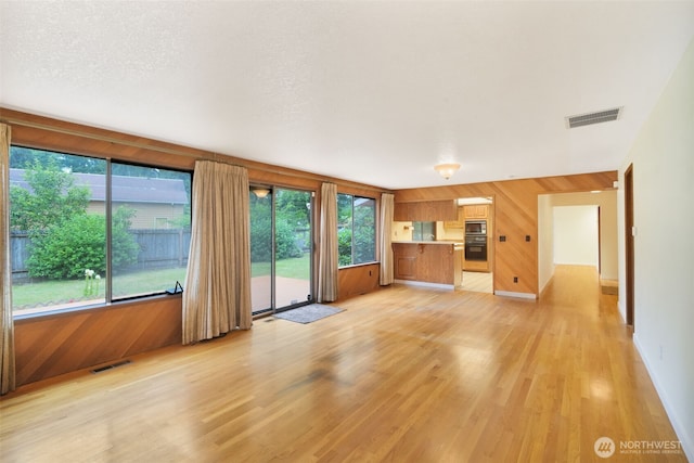 2004 SW 306th Pl, Federal Way, WA 98023 - unfurnished living room featuring wood walls and light wood-type flooring