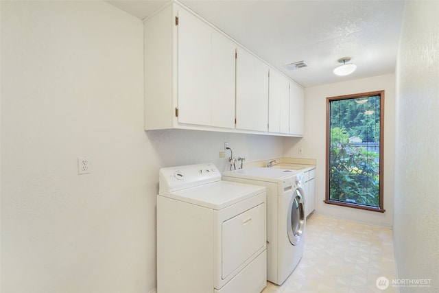 2004 SW 306th Pl, Federal Way, WA 98023 - washroom with cabinet space, washing machine and dryer, light flooring, and a textured ceiling