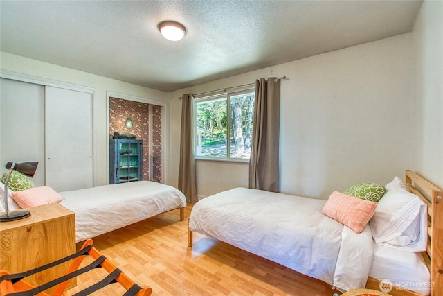 339 Highlands Dr, Orcas Island, WA 98245 - bedroom featuring wood finished floors and a textured ceiling