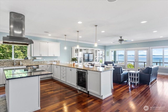 3811 N Dale St, Tacoma, WA 98407 - kitchen with wine cooler, open floor plan, island range hood, healthy amount of natural light, and recessed lighting