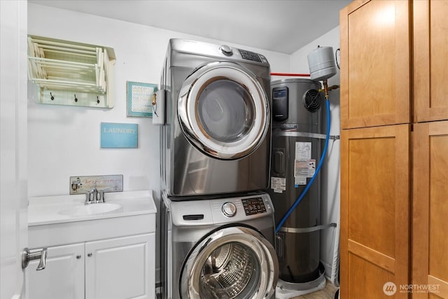3811 N Dale St, Tacoma, WA 98407 - washroom featuring stacked washing machine and dryer, cabinet space, and water heater
