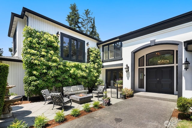 8234 NE 8th St, Medina, WA 98039 - view of exterior entry featuring french doors and a patio
