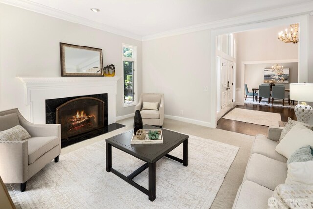 8234 NE 8th St, Medina, WA 98039 - living room featuring a chandelier, crown molding, and a fireplace with flush hearth