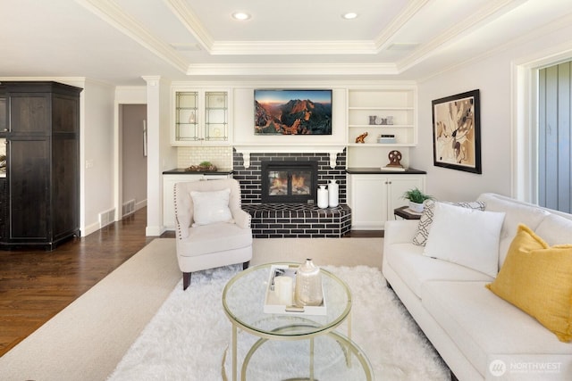 8234 NE 8th St, Medina, WA 98039 - living room featuring a brick fireplace, dark wood-style floors, ornamental molding, and a tray ceiling