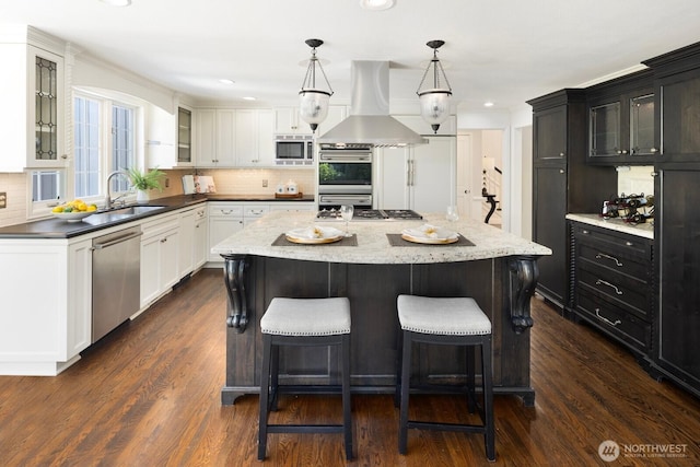8234 NE 8th St, Medina, WA 98039 - kitchen with appliances with stainless steel finishes, exhaust hood, a center island, white cabinets, and glass insert cabinets