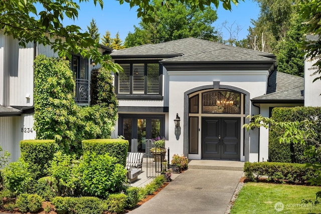 8234 NE 8th St, Medina, WA 98039 - view of front of home with a shingled roof, stucco siding, and french doors