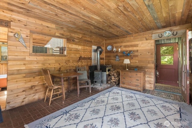 48911 Mountain Loop Hwy, Granite Falls, WA 98252 - dining space featuring wood ceiling, wooden walls, a wood stove, and brick patterned flooring