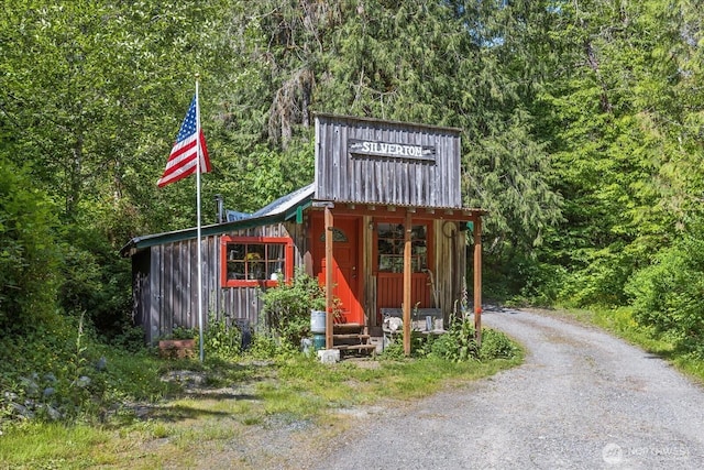 48911 Mountain Loop Hwy, Granite Falls, WA 98252 - view of outdoor structure featuring a wooded view, gravel driveway, and entry steps