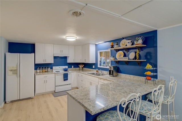 1411 297th Ln, Ocean Park, WA 98640 - kitchen featuring white appliances, white cabinetry, light wood-style floors, a peninsula, and open shelves