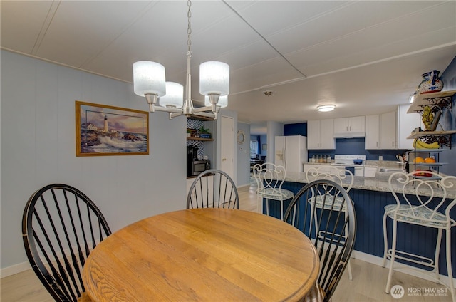1411 297th Ln, Ocean Park, WA 98640 - dining area with light wood finished floors and a chandelier