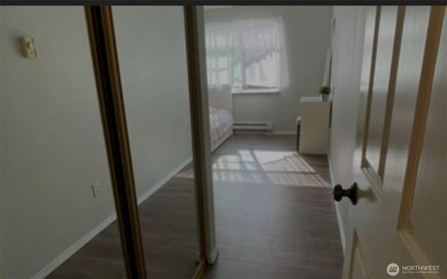 1009 112th St Unit D304, Everett, WA 98208 - corridor featuring a baseboard heating unit and wood finished floors