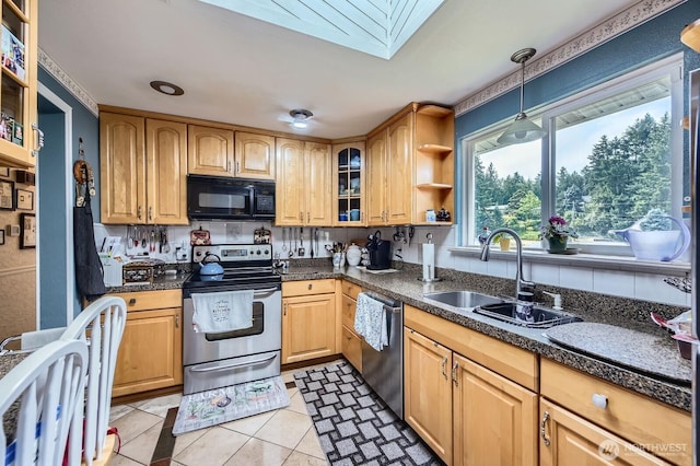 21520 36th Avenue Ct E, Spanaway, WA 98387 - kitchen featuring stainless steel appliances, a skylight, dark countertops, glass insert cabinets, and hanging light fixtures