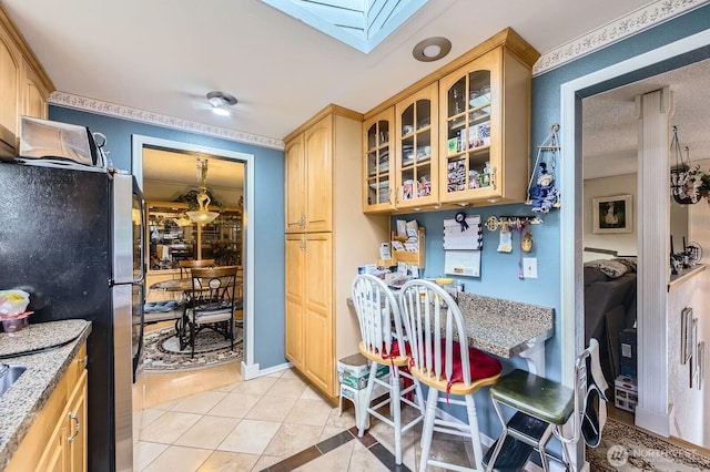 21520 36th Avenue Ct E, Spanaway, WA 98387 - dining room featuring a skylight and light tile patterned flooring