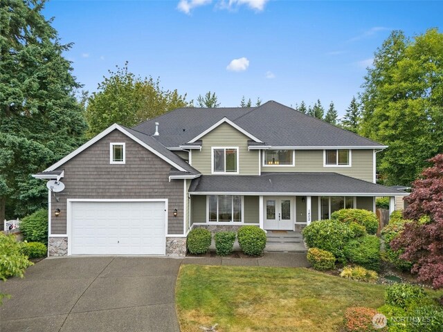 1402 180th Ave E, Lake Tapps, WA 98391 - view of front of property with driveway, stone siding, french doors, and roof with shingles