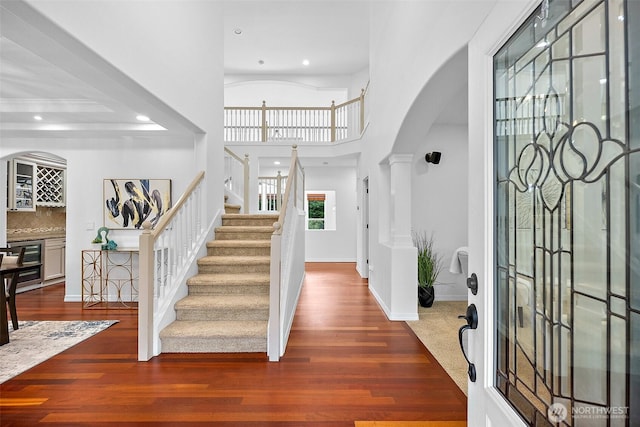 1402 180th Ave E, Lake Tapps, WA 98391 - foyer entrance featuring recessed lighting, arched walkways, wood finished floors, stairway, and a towering ceiling