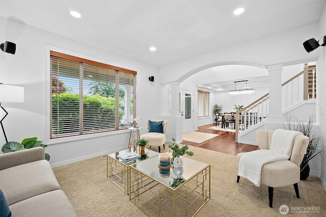 1402 180th Ave E, Lake Tapps, WA 98391 - living room featuring arched walkways, decorative columns, recessed lighting, and stairs