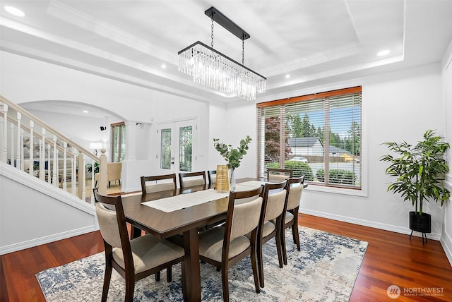 1402 180th Ave E, Lake Tapps, WA 98391 - dining room with a tray ceiling, arched walkways, french doors, recessed lighting, and wood finished floors
