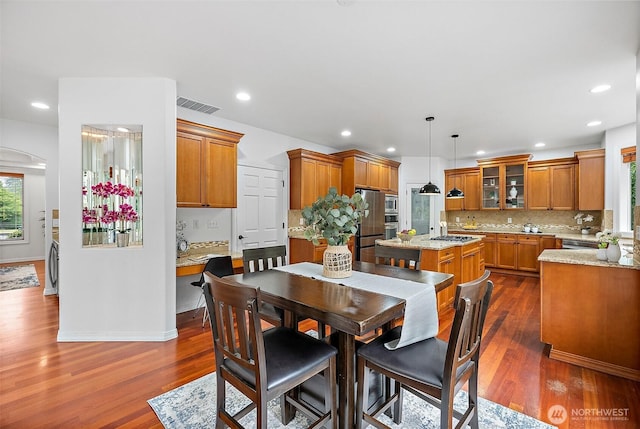1402 180th Ave E, Lake Tapps, WA 98391 - dining room featuring dark wood-style floors, recessed lighting, and washer / clothes dryer