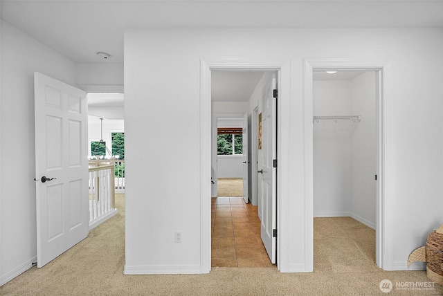 1402 180th Ave E, Lake Tapps, WA 98391 - unfurnished bedroom with a walk in closet, multiple windows, a closet, and carpet floors
