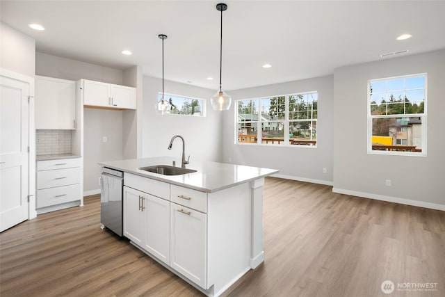 544 SW 97th St Unit 5, Seattle, WA 98106 - kitchen featuring stainless steel dishwasher, light wood finished floors, recessed lighting, light countertops, and white cabinets