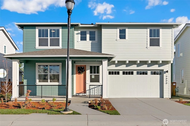 9898 5th Ln SW Unit 23, Seattle, WA 98106 - view of front facade featuring a porch, a garage, and driveway