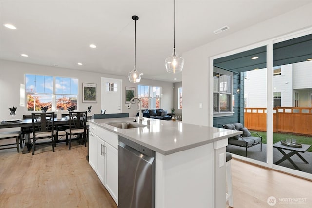 9898 5th Ln SW Unit 23, Seattle, WA 98106 - kitchen with stainless steel dishwasher, light wood-style floors, open floor plan, and recessed lighting