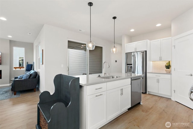 9898 5th Ln SW Unit 23, Seattle, WA 98106 - kitchen with stainless steel dishwasher, light wood-style floors, open floor plan, tasteful backsplash, and recessed lighting
