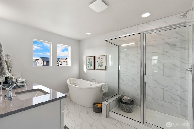 9898 5th Ln SW Unit 23, Seattle, WA 98106 - full bath featuring marble look tile flooring, a freestanding bath, a shower stall, vanity, and recessed lighting