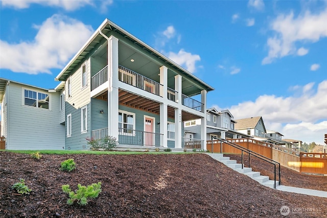 9898 5th Ln SW Unit 23, Seattle, WA 98106 - back of property with covered porch, a balcony, and a residential view