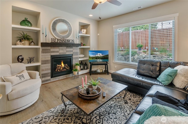 24220 93rd Ct S, Kent, WA 98030 - living room with built in features, ceiling fan, a fireplace, and wood finished floors