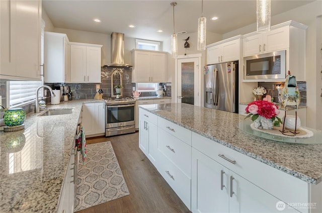 24220 93rd Ct S, Kent, WA 98030 - kitchen featuring appliances with stainless steel finishes, wall chimney exhaust hood, tasteful backsplash, white cabinetry, and recessed lighting