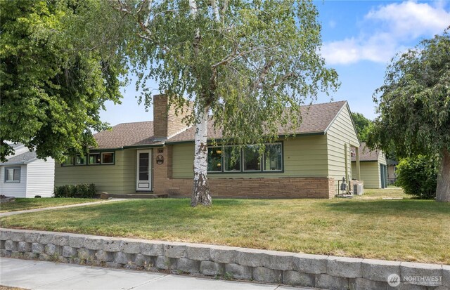 308 2nd Ave, Harrington, WA 99134 - ranch-style house with a front yard, a chimney, and a shingled roof