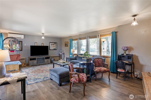 308 2nd Ave, Harrington, WA 99134 - living area with an AC wall unit and wood finished floors