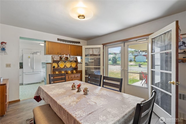 308 2nd Ave, Harrington, WA 99134 - dining room with french doors, light wood-type flooring, and radiator