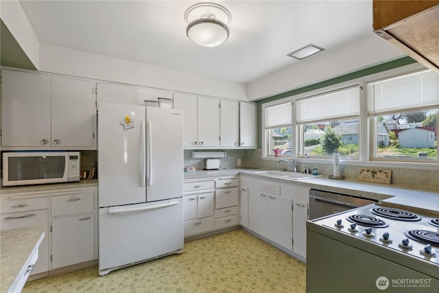 308 2nd Ave, Harrington, WA 99134 - kitchen with white appliances, light countertops, tasteful backsplash, and white cabinetry