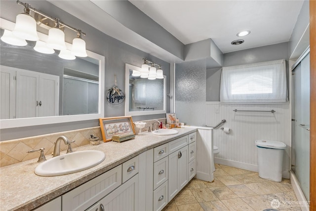 308 2nd Ave, Harrington, WA 99134 - full bath with double vanity, decorative backsplash, and an enclosed shower