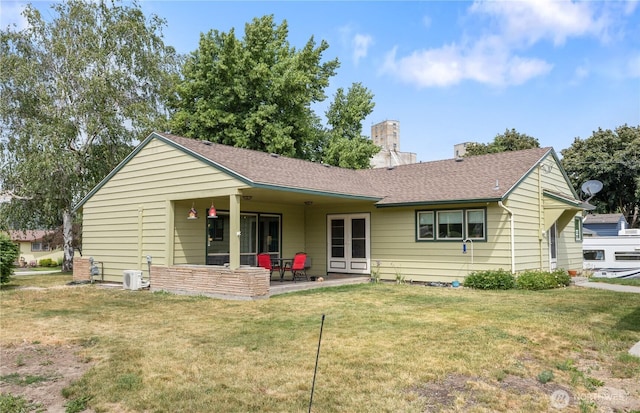 308 2nd Ave, Harrington, WA 99134 - back of house with a chimney, a yard, a patio area, and a shingled roof