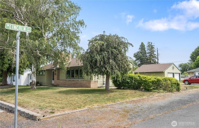 308 2nd Ave, Harrington, WA 99134 - view of front of house featuring a front lawn, brick siding, and a garage