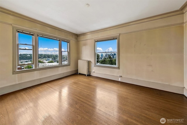 1902 Bigelow Ave N Unit 301, Seattle, WA 98109 - unfurnished room featuring radiator, wood-type flooring, and ornamental molding